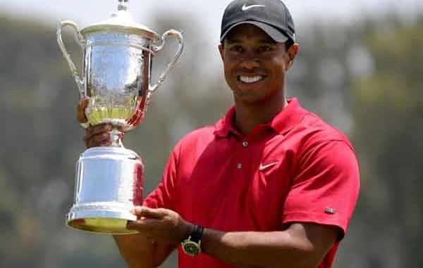 Tiger Woods holding a US Open trophy