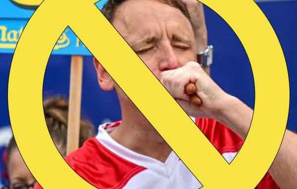 Joey Chestnut eating hot dogs with a no symbol placed over his face