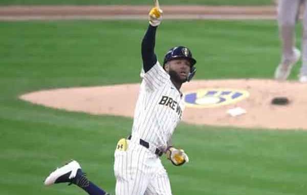 a Milwaukee Brewer rounding the bases and pointing to the sky