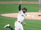 a Milwaukee Brewer rounding the bases and pointing to the sky